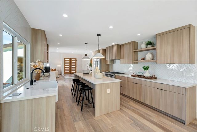 a very nice looking living room with a large window and dining table
