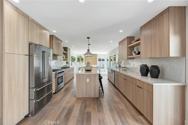 a large kitchen with a table and chairs