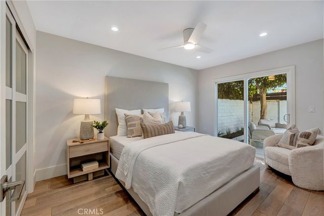a spacious bedroom with a bed and a painting on the wall