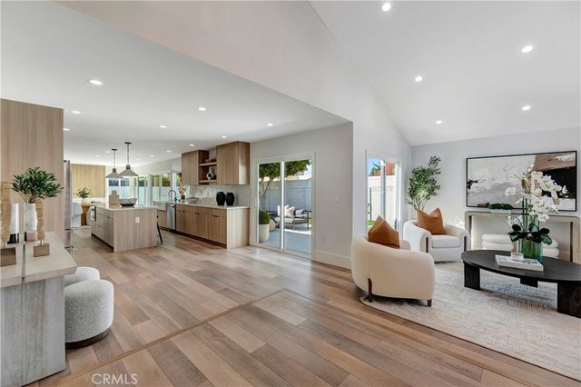 a living room with furniture chandelier and a chandelier