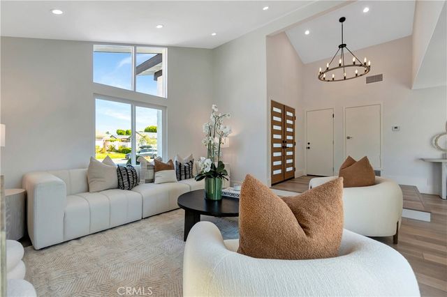 a living room with furniture a rug and a large window