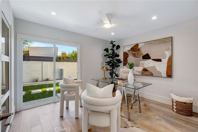 a view of backyard of house with seating space