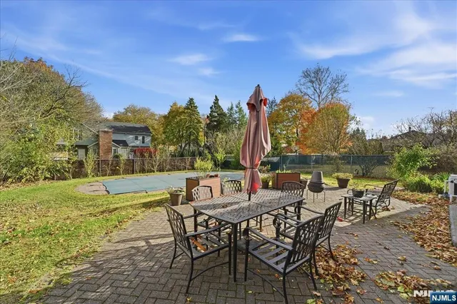 a view of a with table and chairs with wooden floor and fence