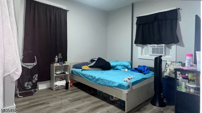 144 Maple Avenue Irvington, NJ 07111 - Photo 12 of 12 a bedroom with a bed and a closet