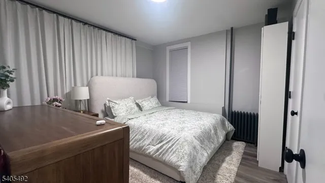 a bed sitting in a bedroom next to a window