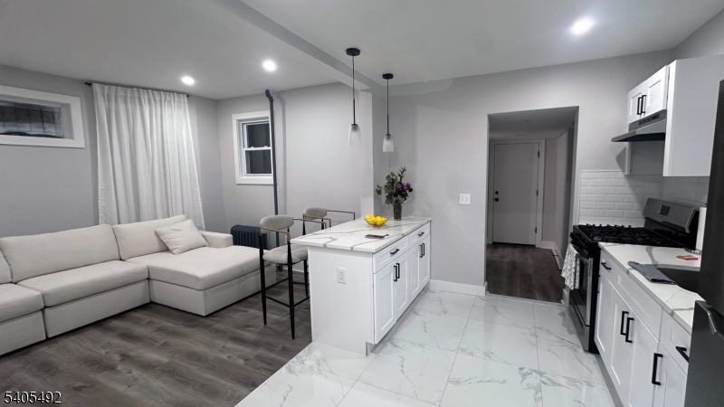 144 Maple Avenue Irvington, NJ 07111 - Photo 4 of 12 a kitchen with a sink stove and refrigerator