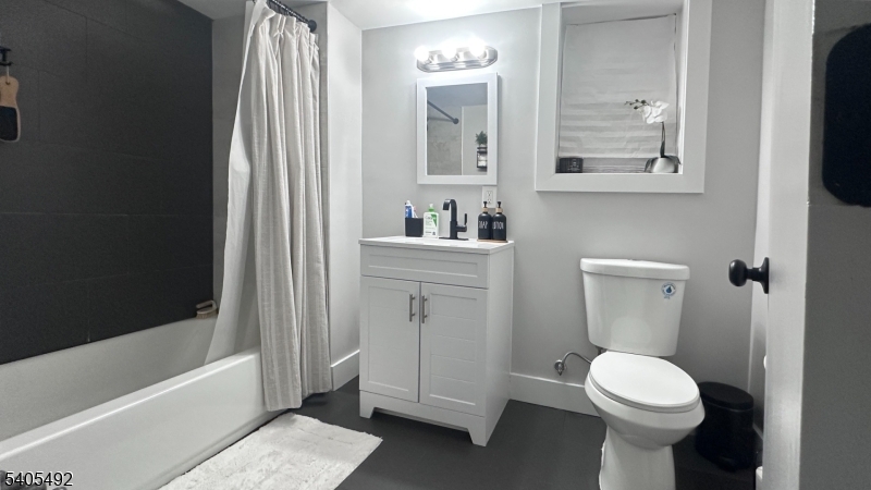 144 Maple Avenue Irvington, NJ 07111 - Photo 6 of 12 a bathroom with a sink toilet and shower