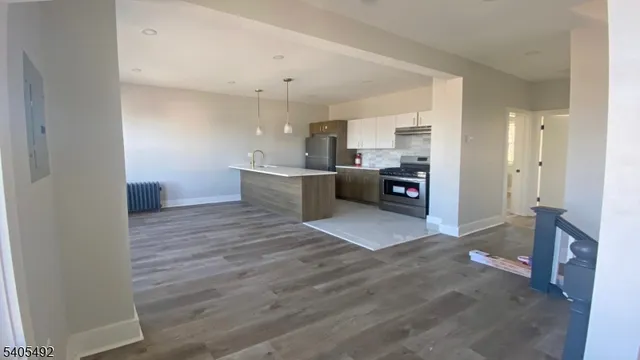 a kitchen with a sink dishwasher a refrigerator and cabinets