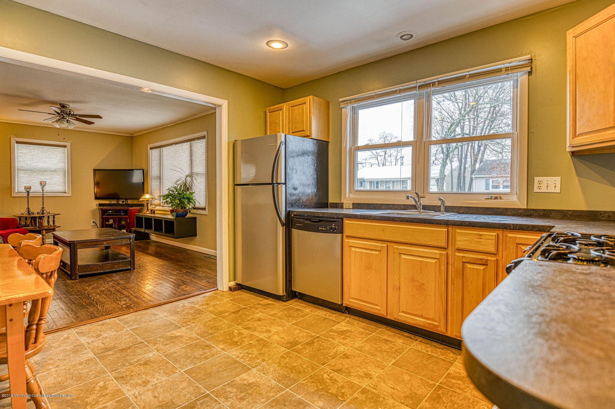 3210 Kickapoo Avenue Point Pleasant, NJ 08742 - Photo 1 of 16 a kitchen with stainless steel appliances granite countertop a refrigerator a stove and a sink dishwasher with wooden floor