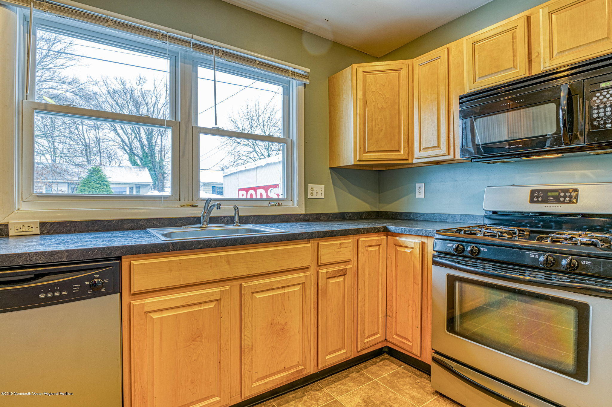 3210 Kickapoo Avenue Point Pleasant, NJ 08742 - Photo 2 of 16 a kitchen with stainless steel appliances granite countertop white cabinets stove a sink and dishwasher