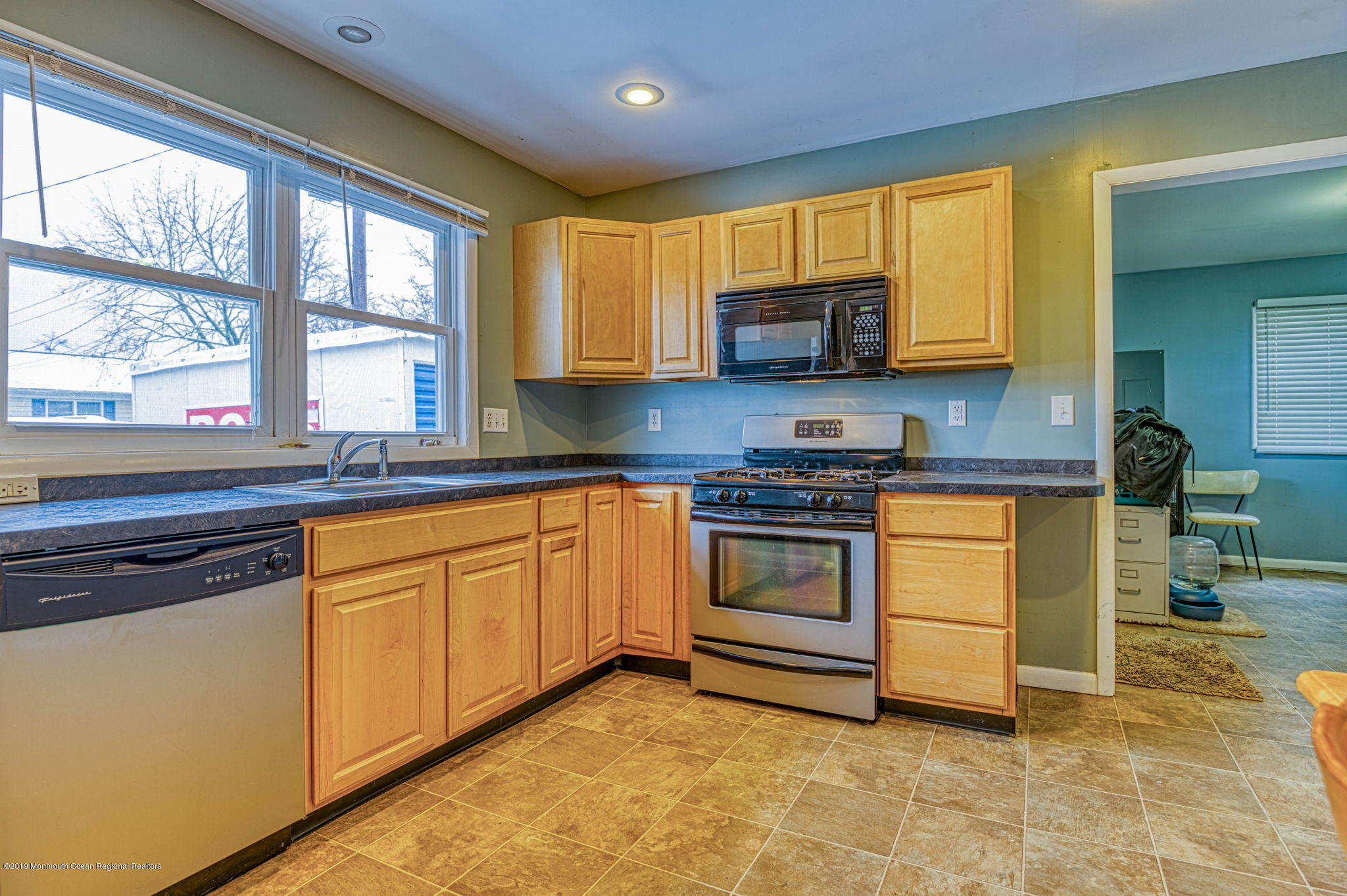 3210 Kickapoo Avenue Point Pleasant, NJ 08742 - Photo 3 of 16 a kitchen with stainless steel appliances granite countertop a stove a sink and a microwave