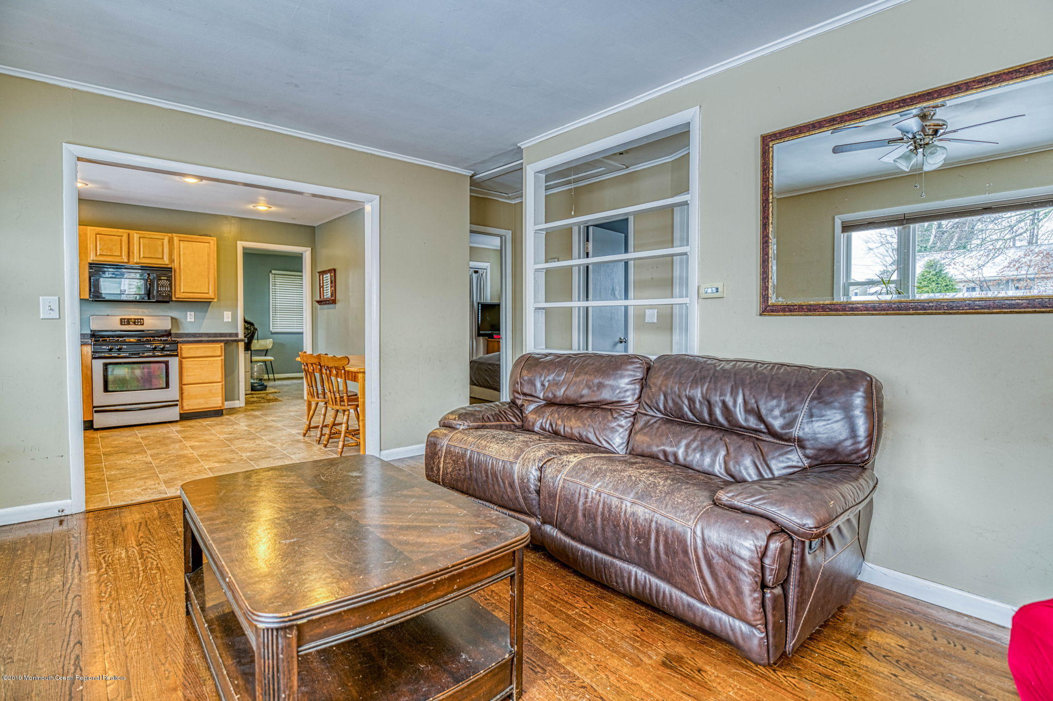 3210 Kickapoo Avenue Point Pleasant, NJ 08742 - Photo 5 of 16 a living room with couches and kitchen view with wooden floor