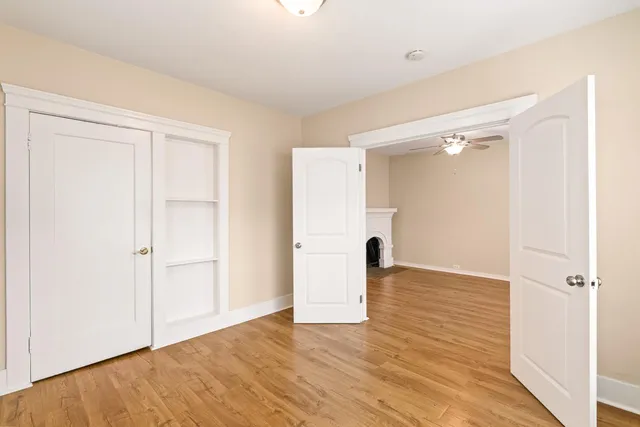 an empty room with wooden floor and closet