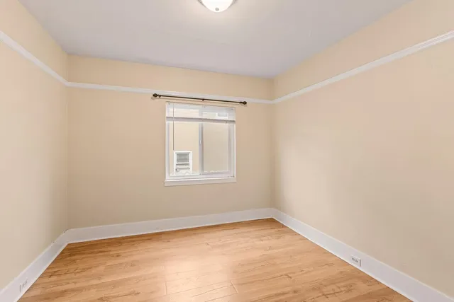 an empty room with a empty space and a window