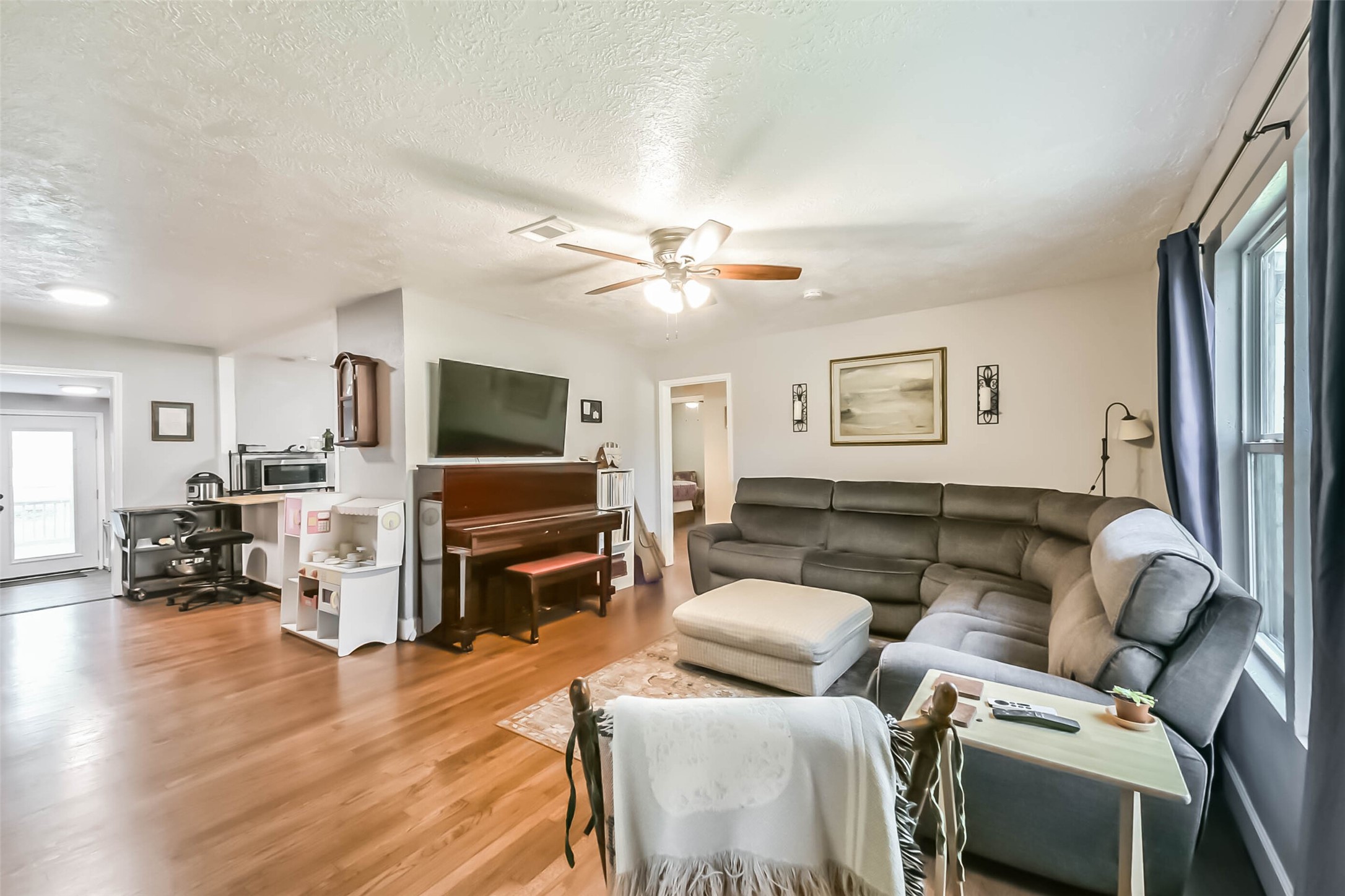 1102 West Hart Avenue Pasadena, TX 77506 - Photo 17 of 40 a living room with furniture and a flat screen tv