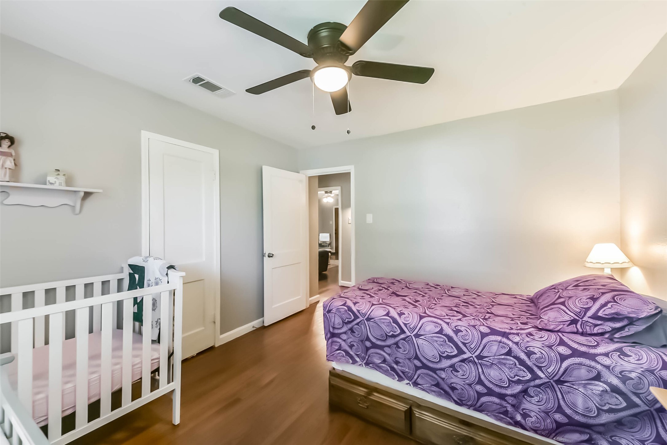 1102 West Hart Avenue Pasadena, TX 77506 - Photo 39 of 40 a bedroom with a bed and a chandelier fan
