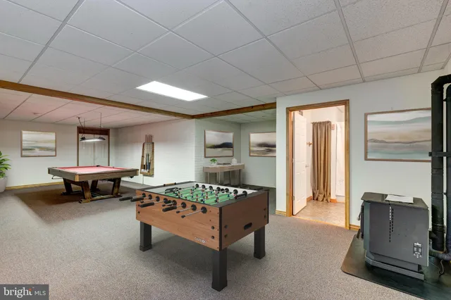 an aerial view of residential houses with outdoor space and trees