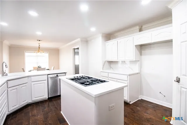 a white bath tub sitting in a spacious bathroom next to a window