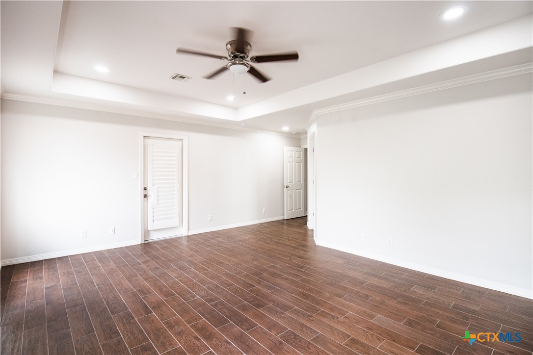 202 Ridge View Victoria, TX 77904 - Photo 21 of 41 a view of a big room with wooden floor a ceiling fan and windows