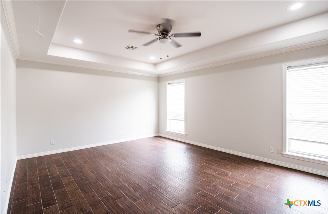 202 Ridge View Victoria, TX 77904 - Photo 22 of 41 an empty room with wooden floor and windows