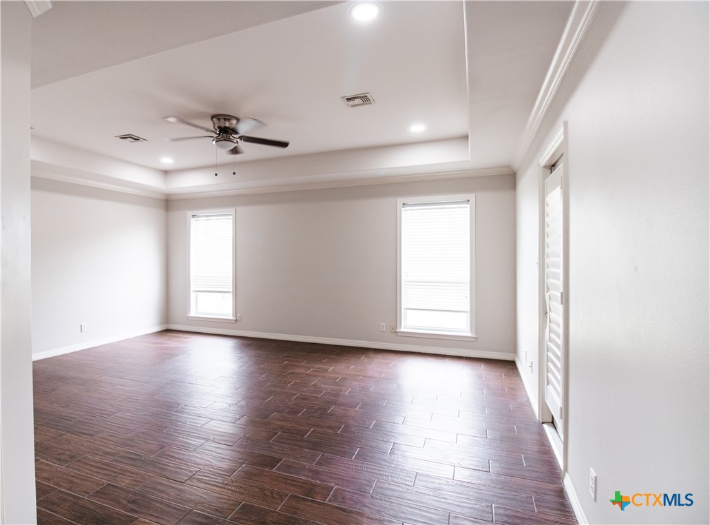 202 Ridge View Victoria, TX 77904 - Photo 23 of 41 a view of empty room with wooden floor and fan