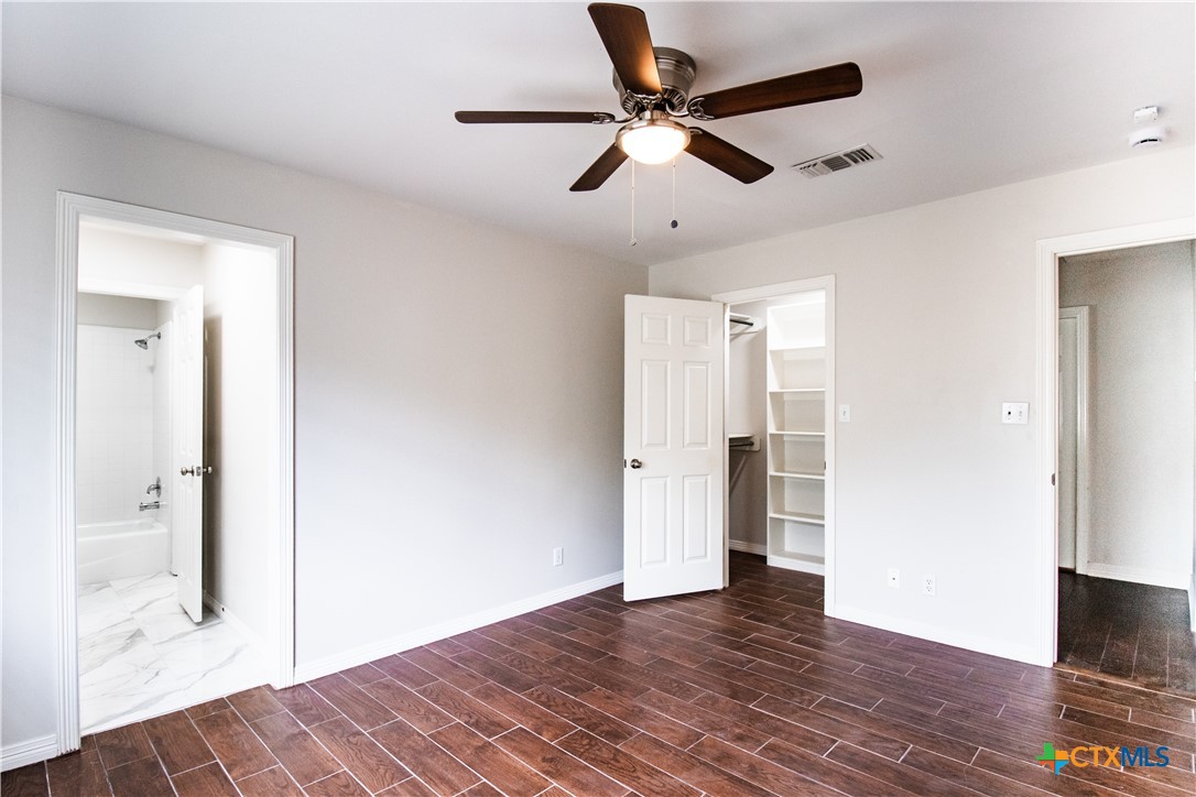202 Ridge View Victoria, TX 77904 - Photo 36 of 41 a view of a hallway with wooden floor and a ceiling fan