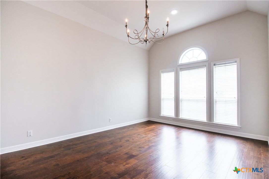 202 Ridge View Victoria, TX 77904 - Photo 5 of 41 an empty room with wooden floor and windows