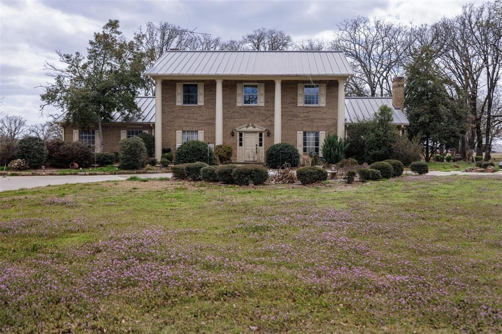 6569 Fm 2947, Unit 4 Quinlan, TX 75474 - Photo 14 of 37 a front view of a house with a yard