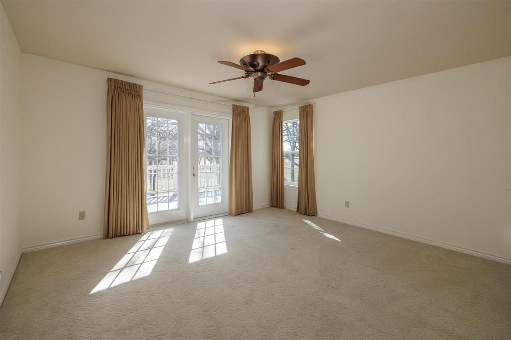 6569 Fm 2947, Unit 4 Quinlan, TX 75474 - Photo 19 of 37 a view of a livingroom with a chandelier fan and windows