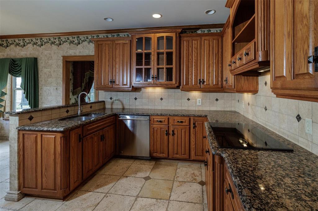 6569 Fm 2947, Unit 4 Quinlan, TX 75474 - Photo 27 of 37 a kitchen with granite countertop a sink and a stove