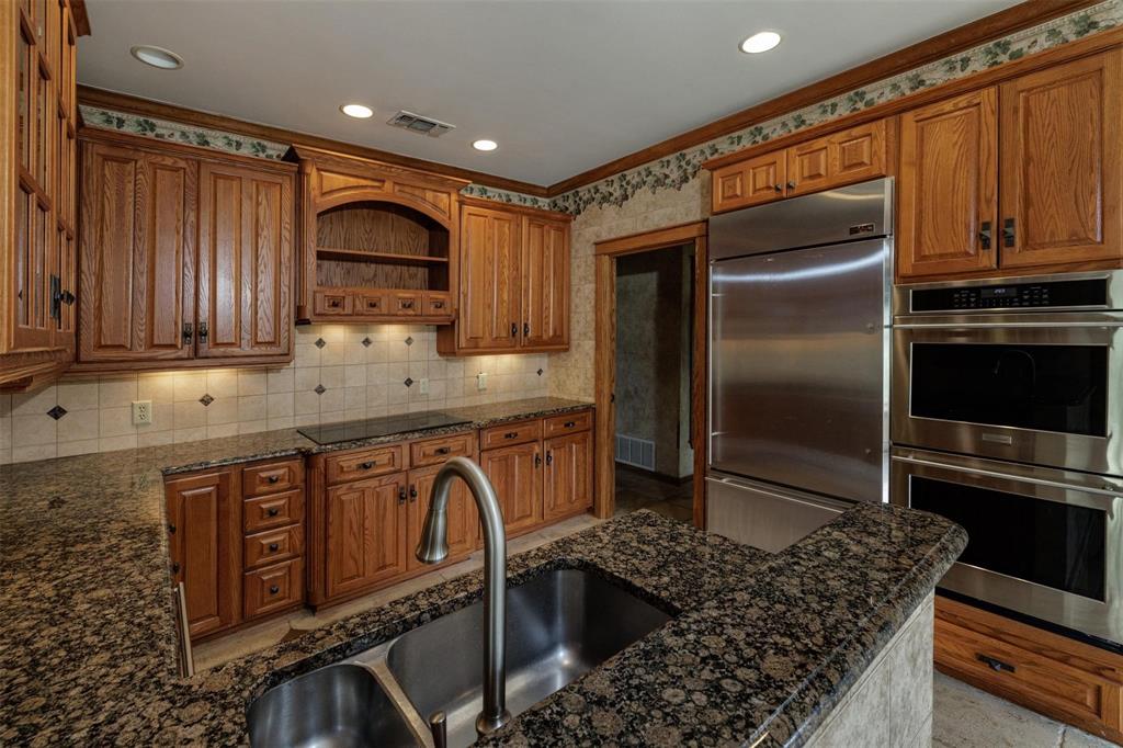 6569 Fm 2947, Unit 4 Quinlan, TX 75474 - Photo 28 of 37 a kitchen with stainless steel appliances granite countertop a sink stove and refrigerator