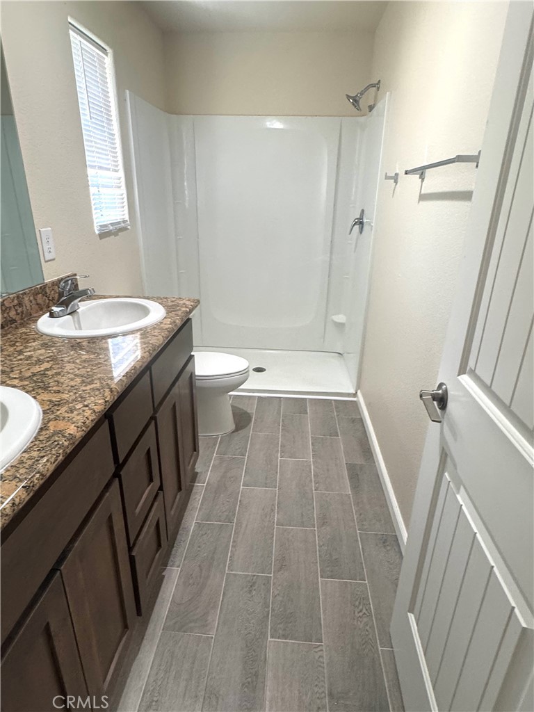 1339 Playa Del Rey Drive Merced, CA 95348 - Photo 38 of 48 a bathroom with a granite countertop sink toilet and shower