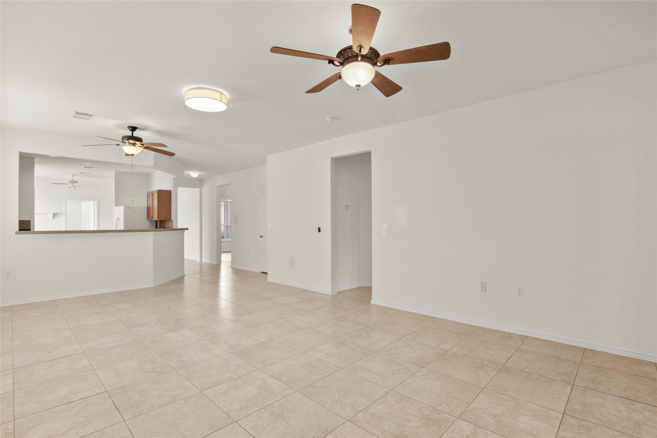 119 Hampton Circle Georgetown, TX 78633 - Photo 11 of 28 Unfurnished living room featuring a ceiling fan and light tile patterned floors