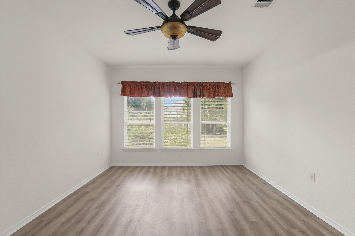 119 Hampton Circle Georgetown, TX 78633 - Photo 17 of 28 Spare room featuring wood finished floors and a ceiling fan
