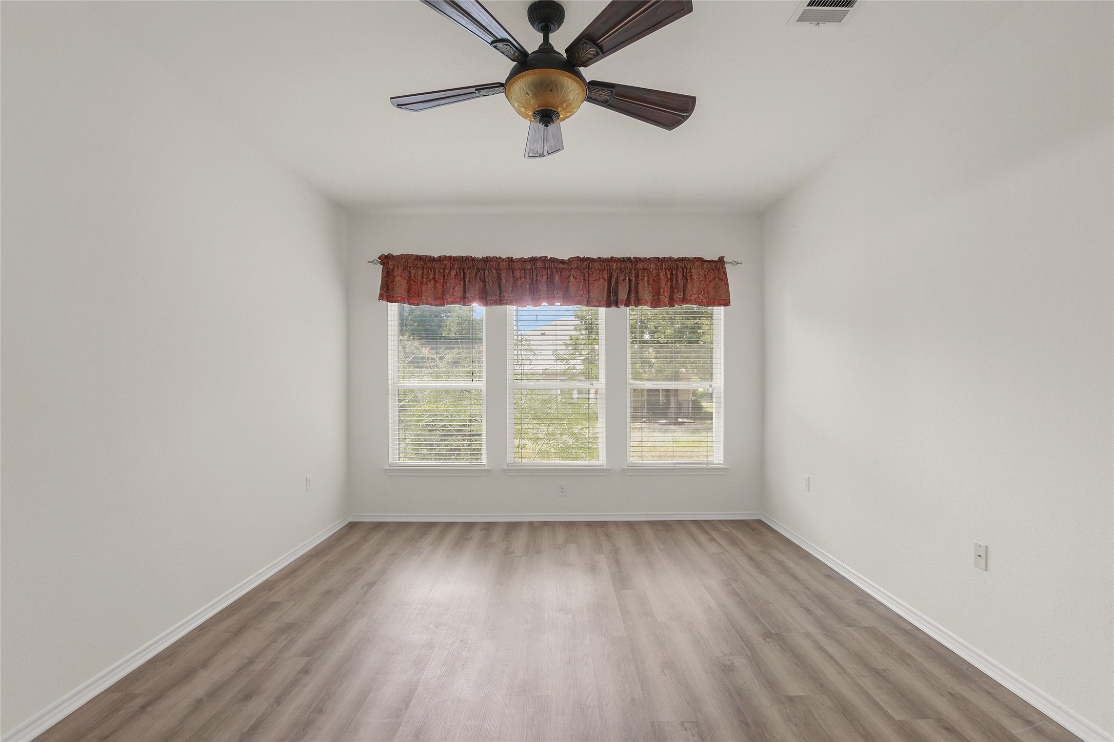 119 Hampton Circle Georgetown, TX 78633 - Photo 17 of 28 Spare room featuring wood finished floors and a ceiling fan