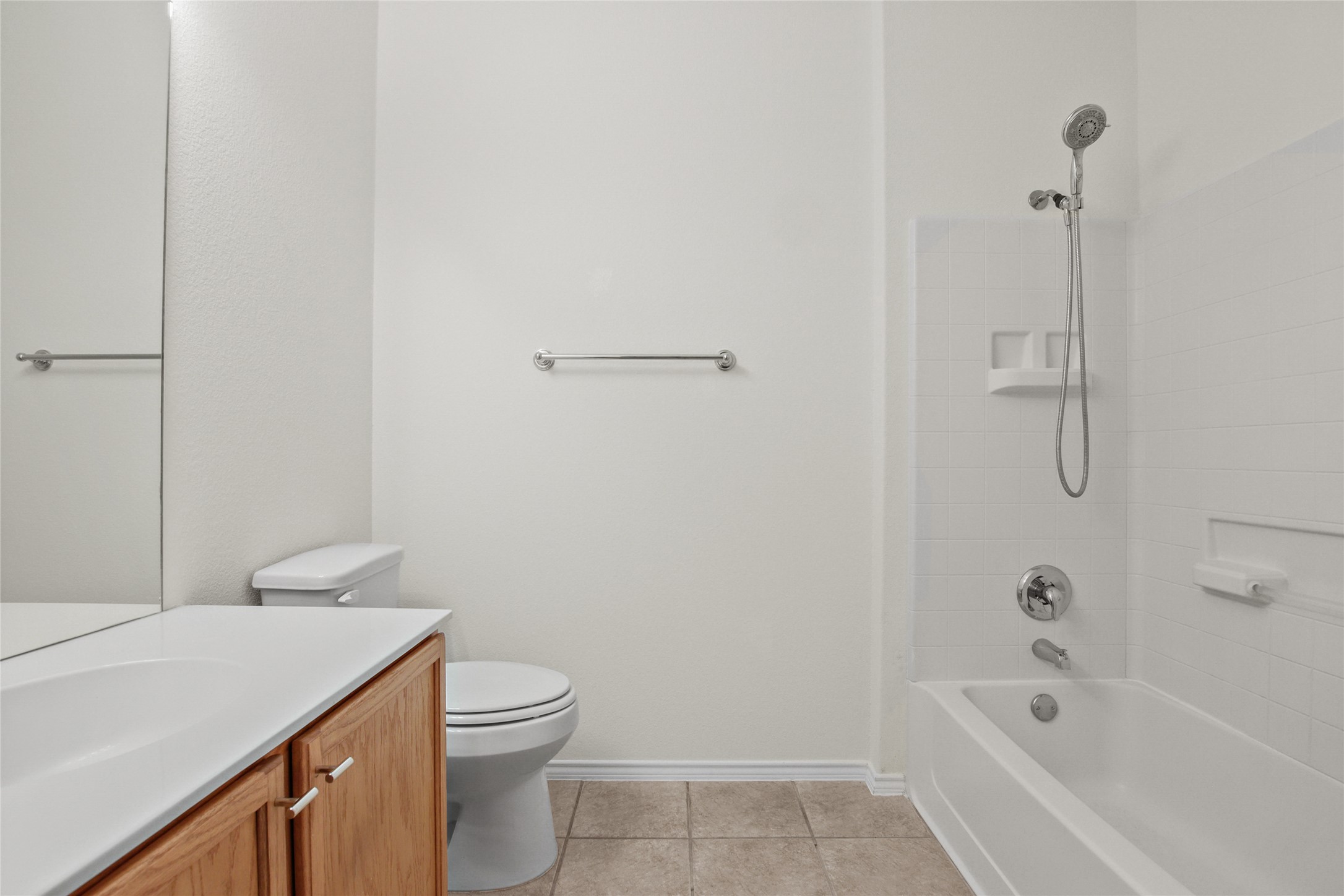 119 Hampton Circle Georgetown, TX 78633 - Photo 21 of 28 Bathroom with tub / shower combination, vanity, and light tile patterned floors