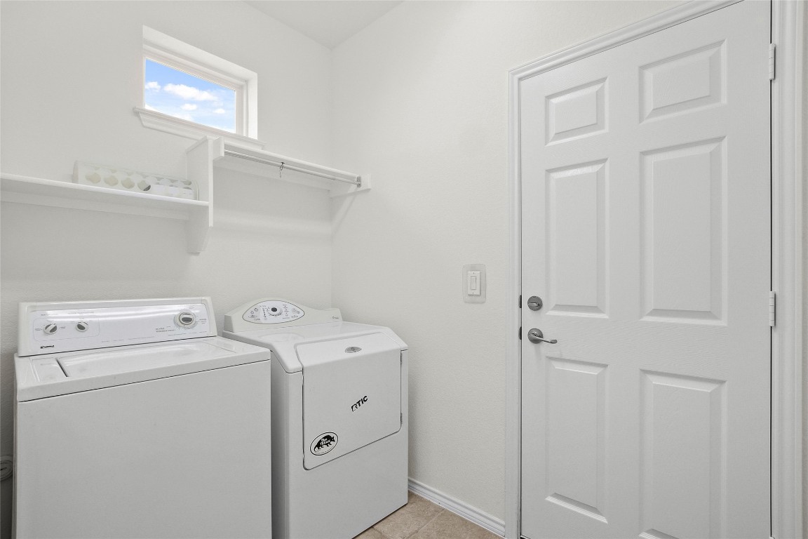 119 Hampton Circle Georgetown, TX 78633 - Photo 23 of 28 Washroom featuring washing machine and clothes dryer and light tile patterned floors