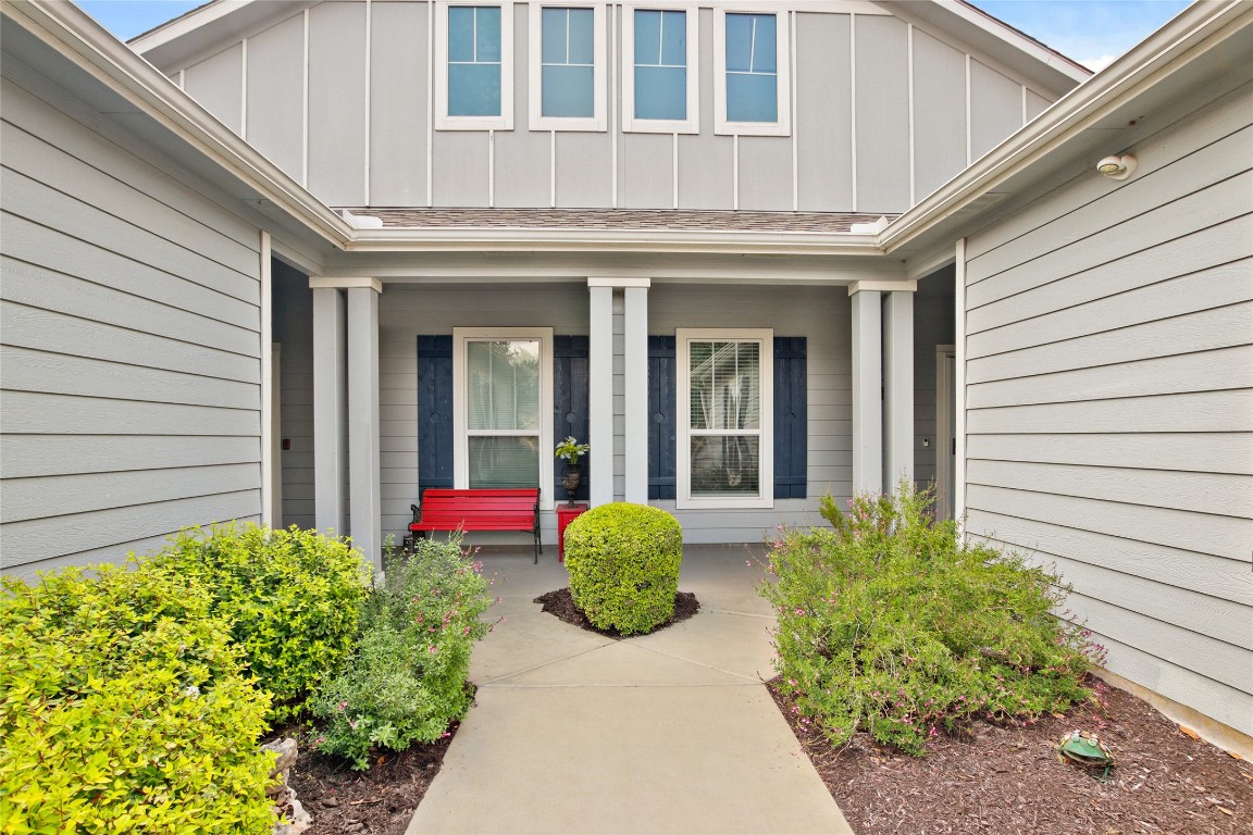 119 Hampton Circle Georgetown, TX 78633 - Photo 4 of 28 Property entrance featuring board and batten siding, covered porch, and a shingled roof