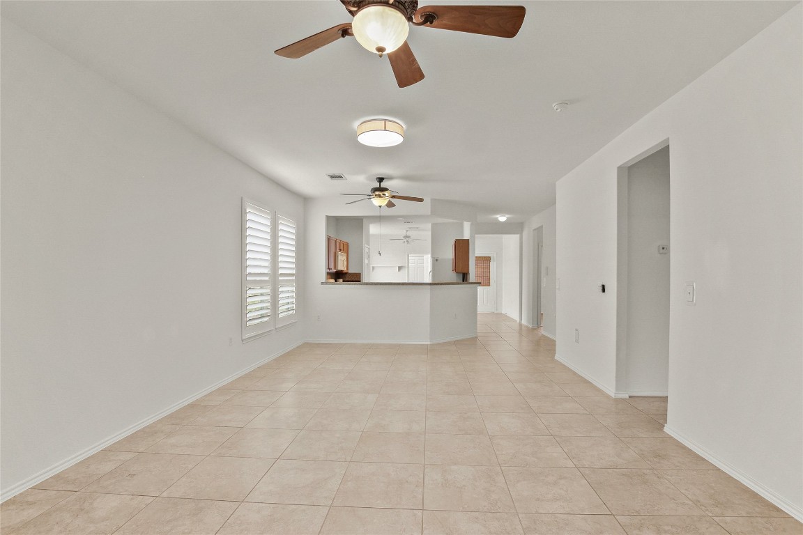 119 Hampton Circle Georgetown, TX 78633 - Photo 9 of 28 Unfurnished living room with light tile patterned floors and a ceiling fan
