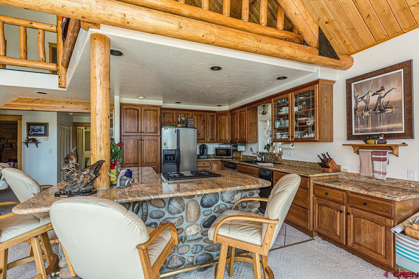 422 North Rainbow Road Durango, CO 81303 - Photo 18 of 34 a view of a kitchen with stainless steel appliances granite countertop a dining table and chairs