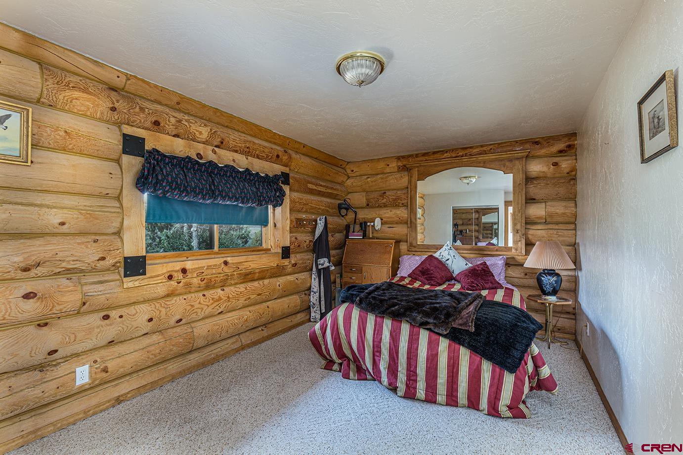 422 North Rainbow Road Durango, CO 81303 - Photo 26 of 34 a bed room with a bed and a window