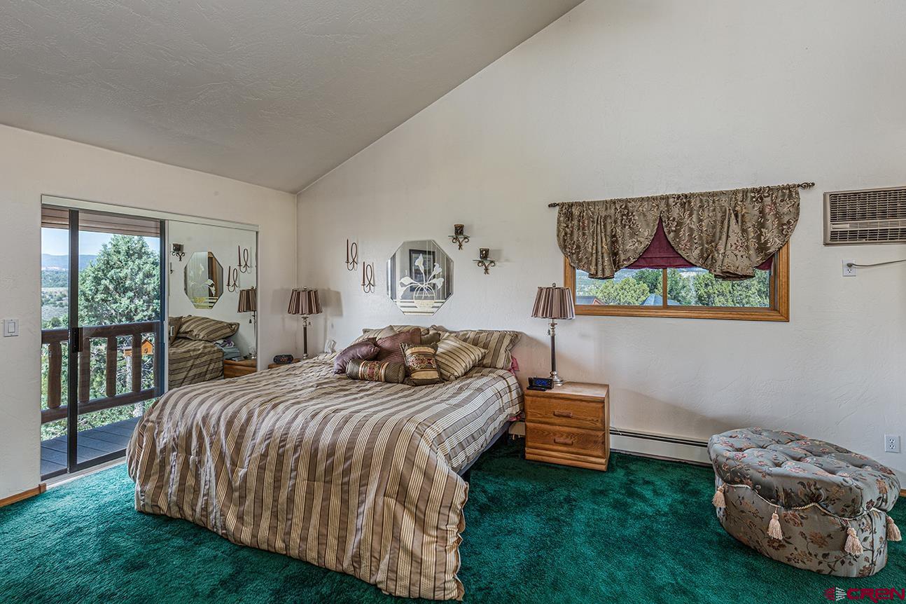 422 North Rainbow Road Durango, CO 81303 - Photo 32 of 34 a bedroom with a bed and a window