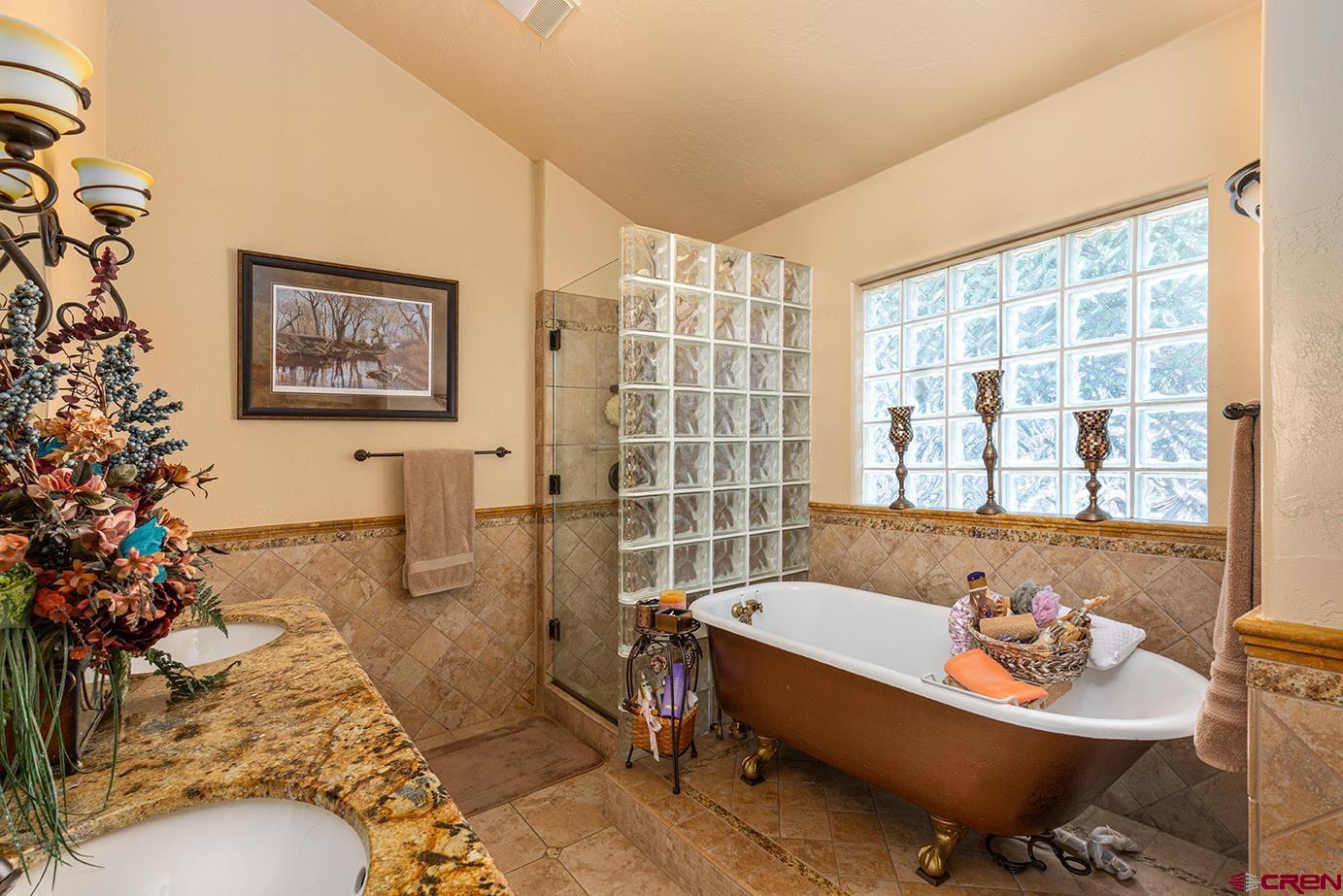 422 North Rainbow Road Durango, CO 81303 - Photo 34 of 34 a bathroom with a bathtub and next to a window
