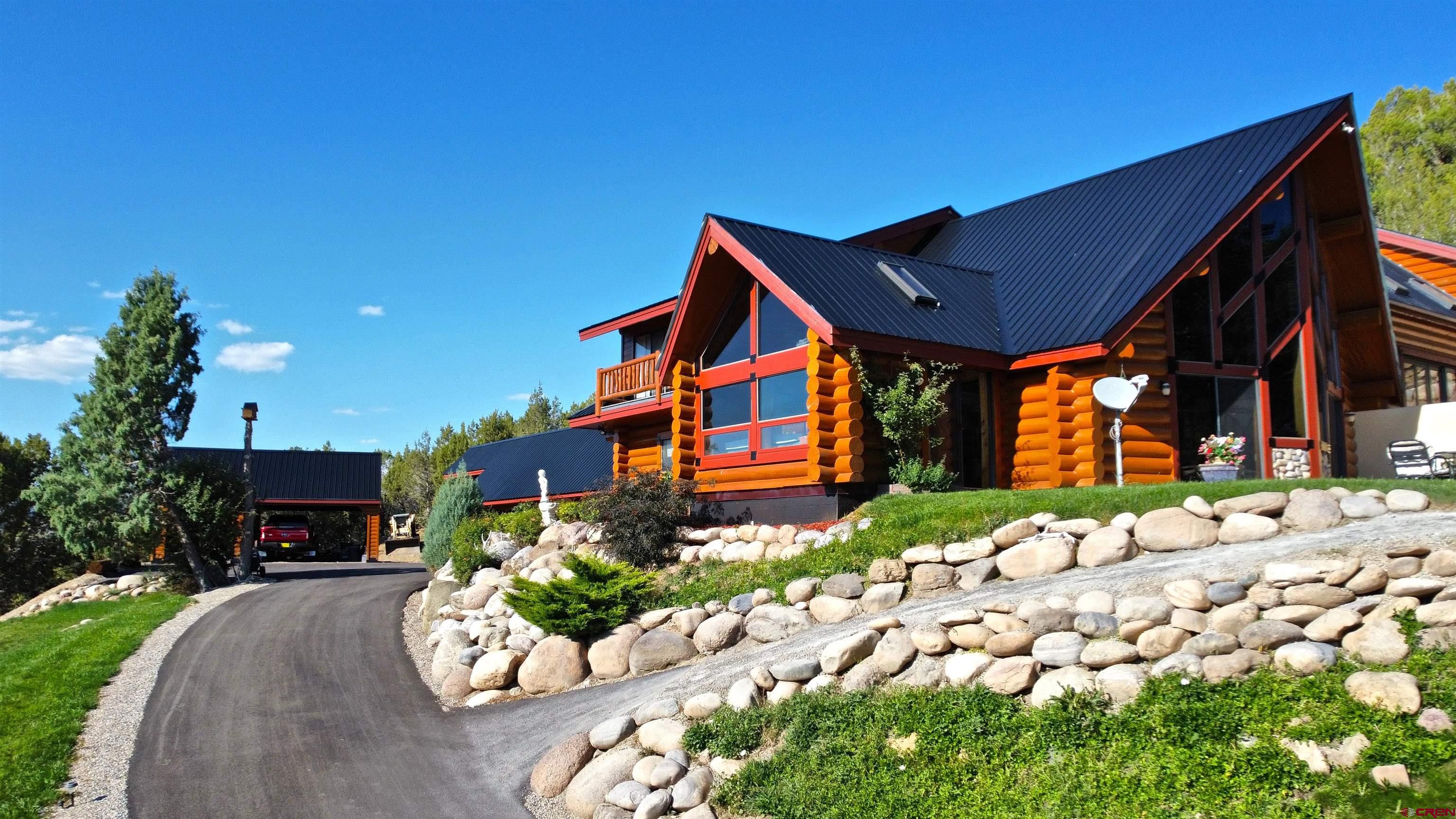 422 North Rainbow Road Durango, CO 81303 - Photo 5 of 34 a front view of a house with a yard