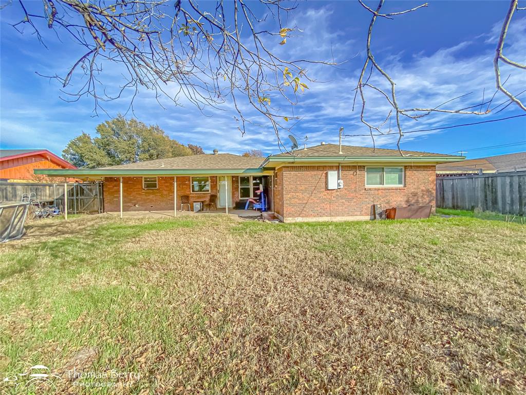 1104 Hickory Street Roscoe, TX 79545 - Photo 19 of 22 a front view of a house with a garden