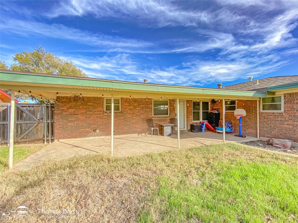 1104 Hickory Street Roscoe, TX 79545 - Photo 21 of 22 a view of a house with a backyard