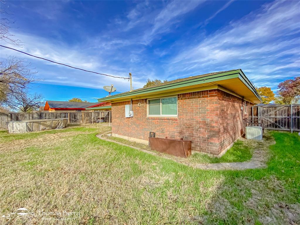 1104 Hickory Street Roscoe, TX 79545 - Photo 22 of 22 a front view of a house with garden