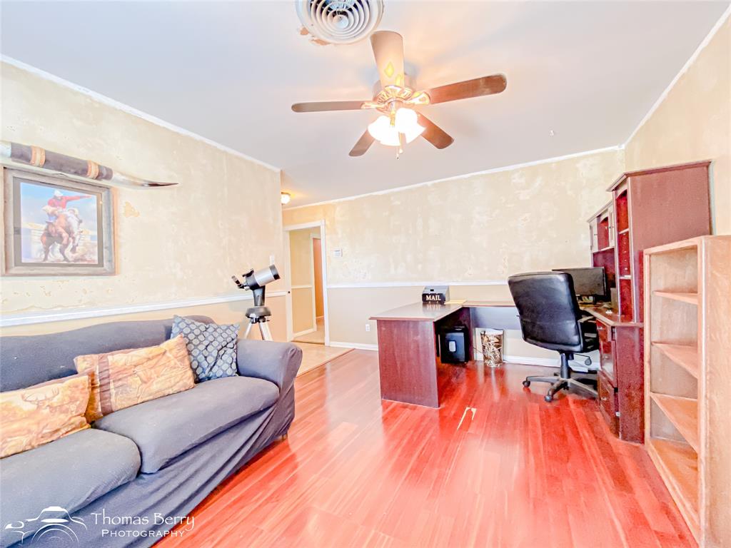 1104 Hickory Street Roscoe, TX 79545 - Photo 4 of 22 a living room with furniture and a wooden floor