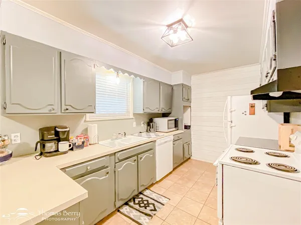 a kitchen with stainless steel appliances a stove a refrigerator and cabinets