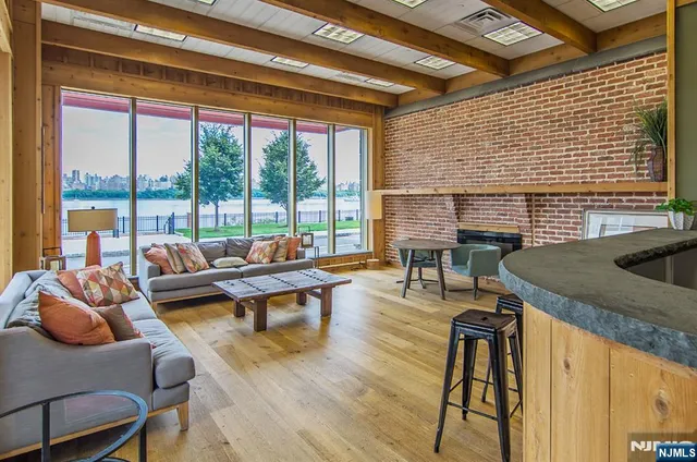 a living room with furniture and a floor to ceiling window